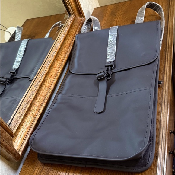 Rains Black Backpack. Clean and ever contemporary.